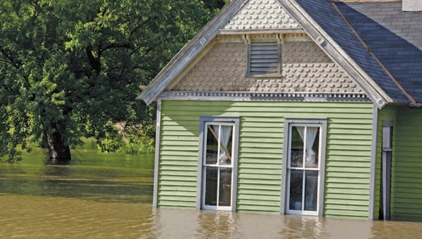 FILE PHOTO | DAILY NEWS HIGH WATER: Flooding, often related to hurricanes, causes much damage to residential and commercial properties in eastern North Carolina. A bill approved by Congress on Thursday offers homeowners relief from large increases in their insurance bills. 