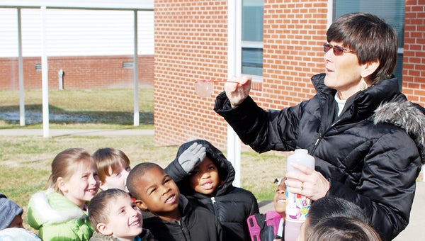  BEAUFORT COUNTY SCHOOLS | CONTRIBUTED CPS SCIENCE LESSON Barbara Boyd, a kindergarten teacher at Chocowinity Primary School, presents an unusual science lesson to her students on a recent frosty morning. The class blew bubbles and watched as they froze and shattered like glass in the cold temperatures.   