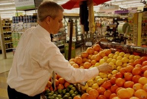 TONY BLACK | DAILY NEWS FRUIT: Reggie Beamon inspects the fruit at the Food Lion on John Small Avenue in Washington. 