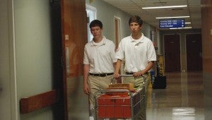 JONATHAN ROWE | DAILY NEWS DUTIES: Vidant youth volunteers Win Martin and Davis Beeman deliver mail and medical documents to patients’ rooms, nurse stations and other destinations. 