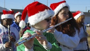 KEVIN SCOTT CUTLER | DAILY NEWS MAKING MUSIC: Trey Branch (foreground) and other members of the Chocowinity Middle School marching band warm up for the Christmas parade. 