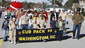 KEVIN SCOTT CUTLER | DAILY NEWS SCOUTING: Cub Scouts, leaders and parents from Pack 99 make their way along N.C. Highway 33 during Saturday's parade. 