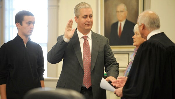 VAIL STEWART RUMLEY | DAILY NEWS THIRD TIME’S A CHARM: Beaufort County Clerk of Superior Court was sworn in for a third time Monday. Here, Paramore was joined by his son, Zach, and his mother, Margaret Vandorp, as Superior Court Judge Wayland Sermons Jr. did the honors. 