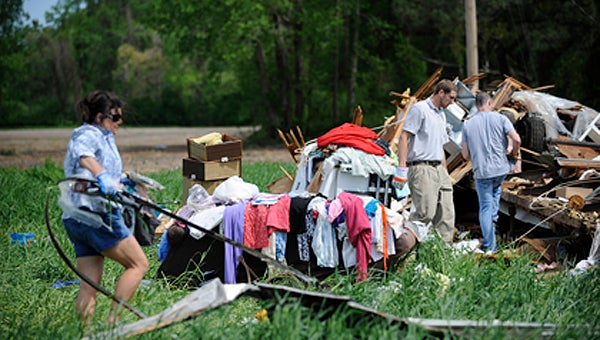 VAIL STEWART RUMLEY | DAILY NEWS PICKING UP THE PIECES: The family of Essie Floyd gathered to pick up the pieces of what remained of the 94-year-old woman’s mobile home the morning after an EF3 tornado ripped through Beaufort County on April 25.