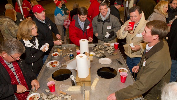 WILL PRESLAR GATHERING OF GRADS: N.C. State grads over the decades gather around steamed oysters at the home of Forrest Sidbury. Sidbury’s wife, Lala, was heavily involved in the local and state alumni association, and he carries on the oyster roast tradition. 