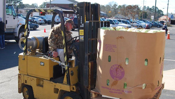 KEVIN SCOTT CUTLER | DAILY NEWS SPEEDY DELIVERY: Greg Cox operates the church's forklift and unloads a pallet of fresh produce. 