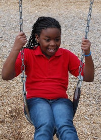 KEVIN SCOTT CUTLER | DAILY NEWS SWING INTO SPRING: Asonti Harper of Chocowinity shirks her heavy winter coat for short sleeves as she enjoys swinging in the sunshine. 
