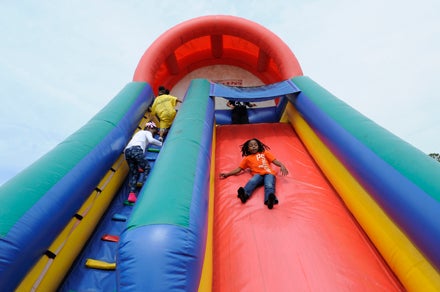 VAIL STEWART RUMLEY | DAILY NEWS GOING DOWNHILL: There was no such thing as too much fun on the blow-up slide, a popular attraction for the children who attended Easter Fest, a celebration thrown by Oakland Raiders’ defensive end C.J. Wilson. 