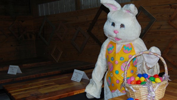 KEVIN SCOTT CUTLER | DAILY NEWS HAPPY EASTER: The Easter bunny, who is slated to be a special guest during Saturday's Spring Celebration at Raised In A Barn Farm in Chocowinity, looks over a selection of handcrafted furniture sold in the farm store. 