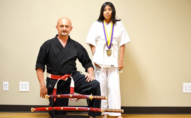 DAVID CUCCHIARA | DAILY NEWS TOP PERFORMER: Washington Karate Academy student Aida Perez took first place in three categories at the 17th Annual Open Martial Arts Tournament at East Carolina University on April 18. Standing to her right is Sensei David Warren.