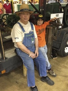 CAROLINE HUDSON | DAILY NEWS RUNS IN THE FAMILY: Chester Smith is a farmer from Belhaven, who showed off his exhibit of antique farm equipment at the Northeast Regional Ag Expo, with the help of his grandson John. 