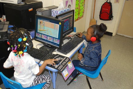 CAROLINE HUDSON | DAILY NEWS TECH SAVVY: Ny'Kiah and Anita play learning computer games during center time on Wednesday morning. 