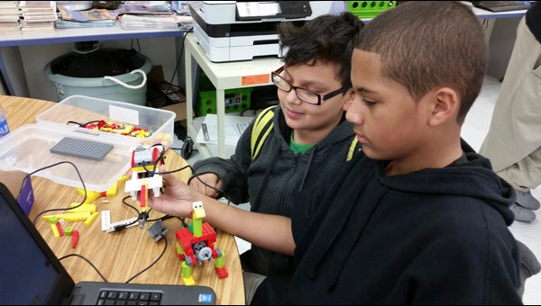 JOHN SMALL ELEMENTARY SCHOOL ROBOTICS: Randy Ibarra (left) and Jayden Turner are busy in the LEGO Robotics lab during the afterschool program at John Small Elementary School. With the introduction to LEGO Robotics this year, the current fifth-graders could participate in LEGO Robotics at P.S. Jones Middle School next year.   