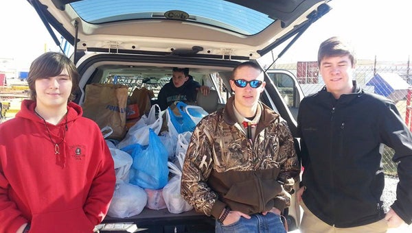 BOY SCOUT TROOP 99 FOOD DRIVE: Boy Scouts in Troop 99 are currently rounding up food from community residents, as part of its Scouting for Food initiative, a community service project coordinated annually by Boy Scout troops throughout the nation. The project involves scouts collecting food and donating it to local food pantries. Pictured are Matthew Puskas (left), Kevin White (inside van) and Austin Hanchey, members of Troop 99 who participated in last year’s initiative and loaded their collected items to take to Eagle’s Wings food pantry. 