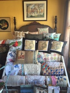 CREATIVITY: A collection of pillows and quilts sits near the front windows. Hubers’ friend Elaine gave her the idea to create the bed-like set up.