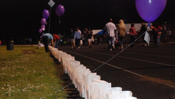 FILE PHOTO | DAILY NEWS LUMINATION: Luminaries, used to honor a lost or surviving loved one, are a big part of the fundraising effort of Beaufort County Relay for Life. Pictured, participants walk the track at Washington High School during Relay, as hundreds of luminaries line the track. 