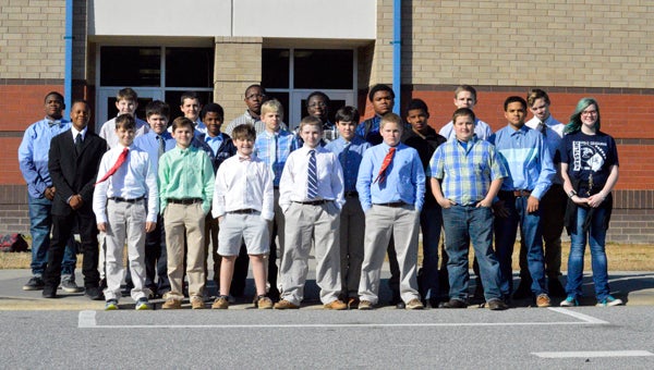 MICHAEL PRUNKA | DAILY NEWS PAUSING FOR A SECOND: The P.S. Jones wrestling team takes a moment to pose for a photo before heading to A.G. Cox for its final match of the season. The Demons dress to impress and have impressed quite a bit this year. 
