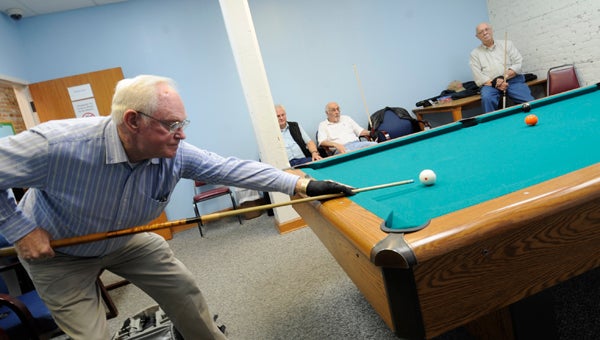 VAIL STEWART RUMLEY POPULAR FACILITY: The Grace Martin Harwell Senior Center, operated by the City of Washington, is popular with area residents, including many who live outside the city limits. The city is seeking county dollars to help pay for providing the services and programs the center offers. Here, Joe Puryear takes a shot during a recent afternoon game of pool at the senior center. 