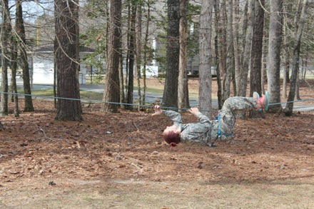 CROSSING OVER: Tori Backs crosses a rope bridge, as part of the raider competition at Washington High.