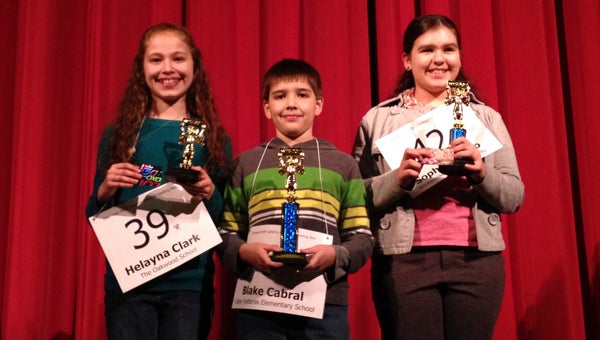 VAIL STEWART RUMLEY | DAILY NEWS DOWNEAST SPELLERS: Blake Cabral (center), from Cape Hatteras Elementary School, will be eastern North Carolina’s representative at the Scipps National Spelling Bee to be held in Washington, D.C. in May. Cabral, pictured here with second-place winner Sophia Chabo (right) of Winterville Charter Academy, and third-place winner Helayna Clark (left), from The Oakwood School in Greenville, won the Downeast Regional Spelling Bee, was held Saturday at the Turnage Theatre. The bee is sponsored by the Washington Daily News and PotashCorp-Aurora. 