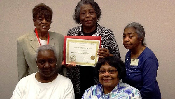 CYNTHIA HEATH SETTING THE BAR: The Beaufort County NCRSP received a designation as a Gold Star Unit based on its extensive outreach and volunteerism in the public school system and community. Pictured, Cynthia Heath (back row, center) and Joyce O’Neal (back, left), with other members of the local unit, accept the award during a NCRSP state convention. 