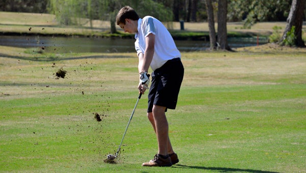 MICHAEL PRUNKA | DAILY NEWS CHIP SHOT: Riley Vanstaalduinen launches the ball, and some dirt, toward the green in a match against Manteo earlier in the season. His consistency as the team’s No. 2 golfer helped lift Northside to its first conference title. 