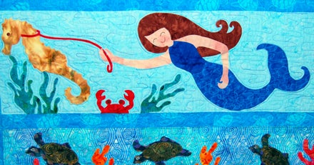 ROW BY ROW: A charming underwater scene is especially appealing in Sharon McClaskey's "Row by Row" lap quilt.