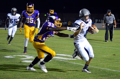Frederick Holscher rolls out of the pocket and scrambles in a non-conference game against Tarboro. All the top-notch opponents early in the season seem to be paying dividends for the Pam Pack.