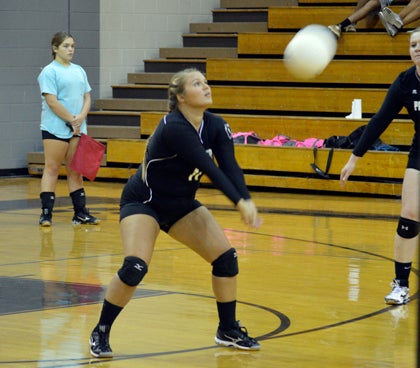 Tiffany Oliver breaks a serve in a conference meeting with Jones Senior. Volleyball seasons across the county are in danger because of Hurricane Matthew and the flooding it brought.